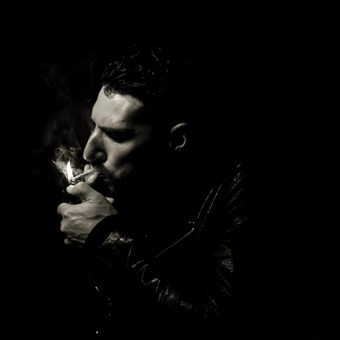 Young Benny lighting up - black-and-white studio portrait
