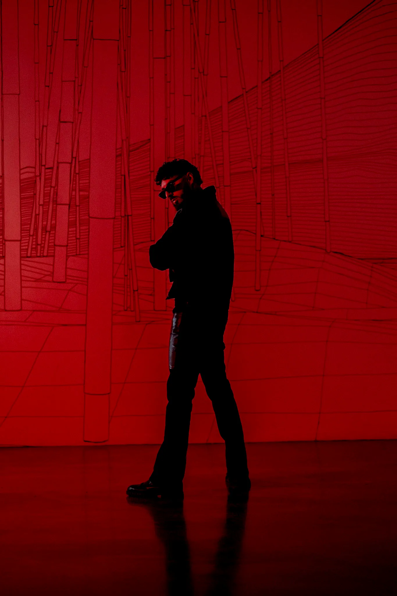 Young Benny in a red-lit room - cinematic press portrait